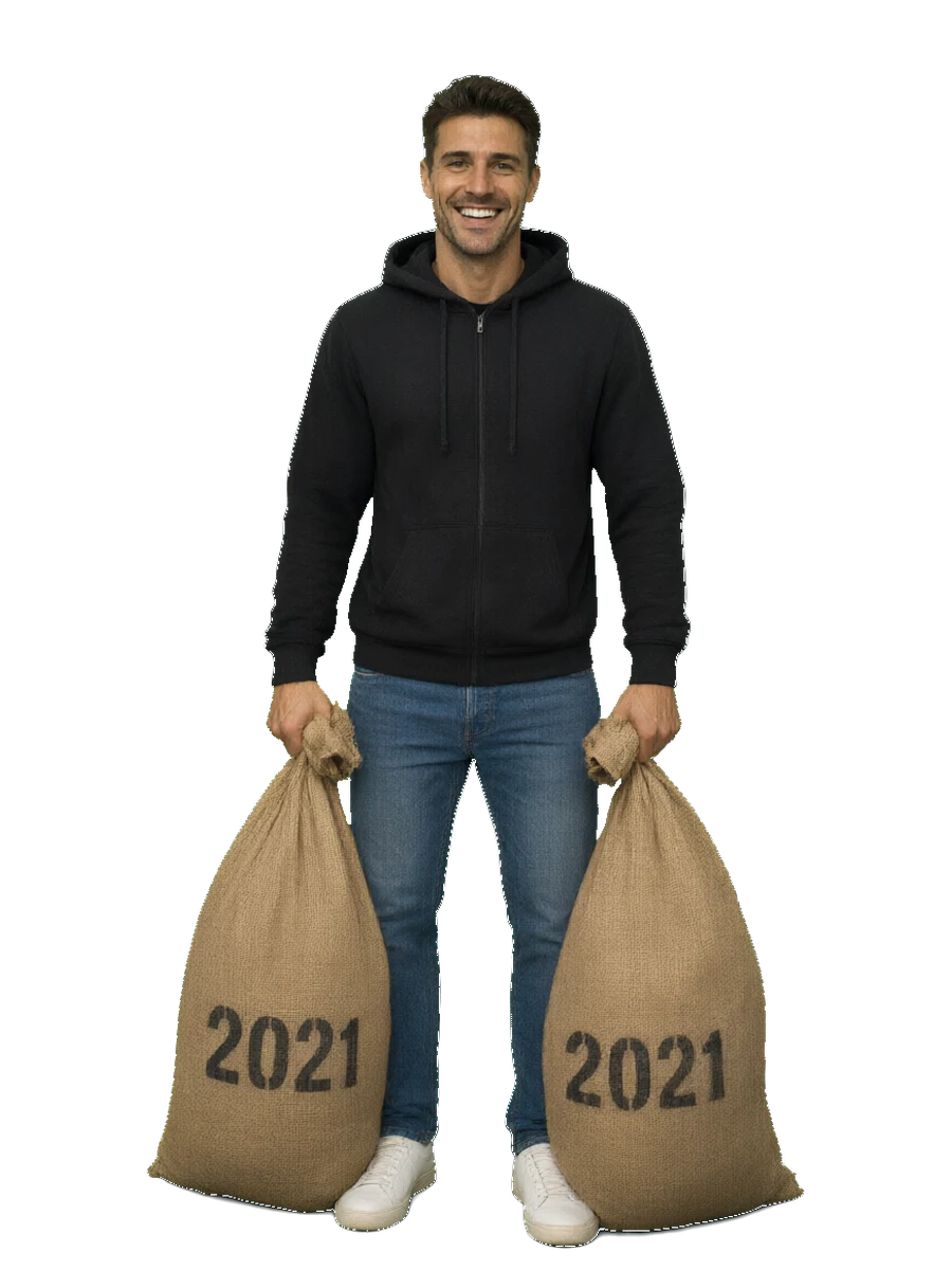 2021: a grinning man in a clean black hoodie and jeans, holding two full sacks stencilled 2021.